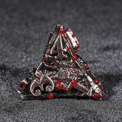 Blood-stained metal dragon head dice set.