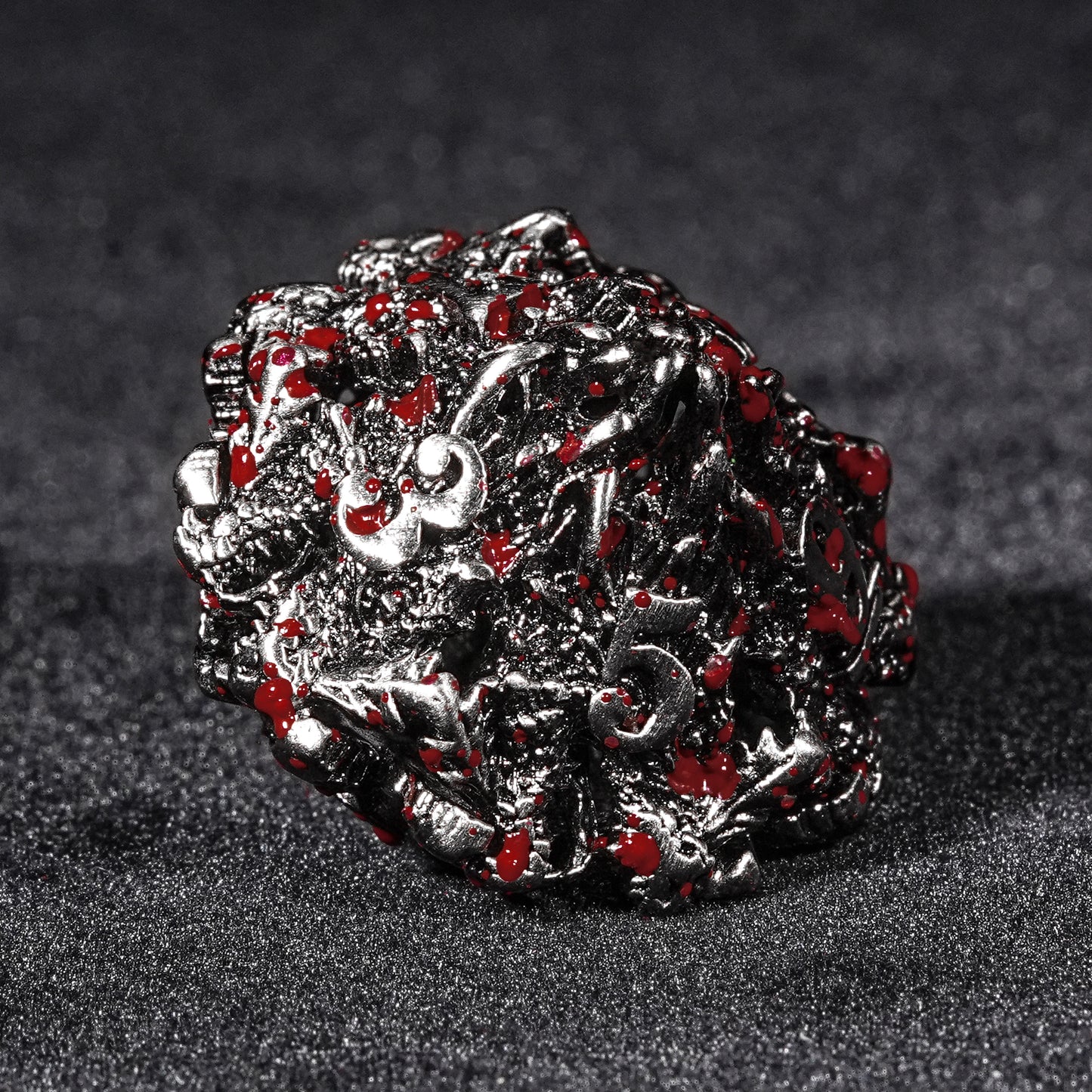 Blood-stained metal dragon head dice set.